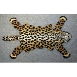 Shenkin hand-crafted Indian tufted wool rug, shaped as a leopard skin, 95 x 140cm.
