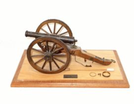 Bronze model of a Napoleonic field gun, L. 35.5cm, H. 15.7cm, on a carriage with accessories, on
