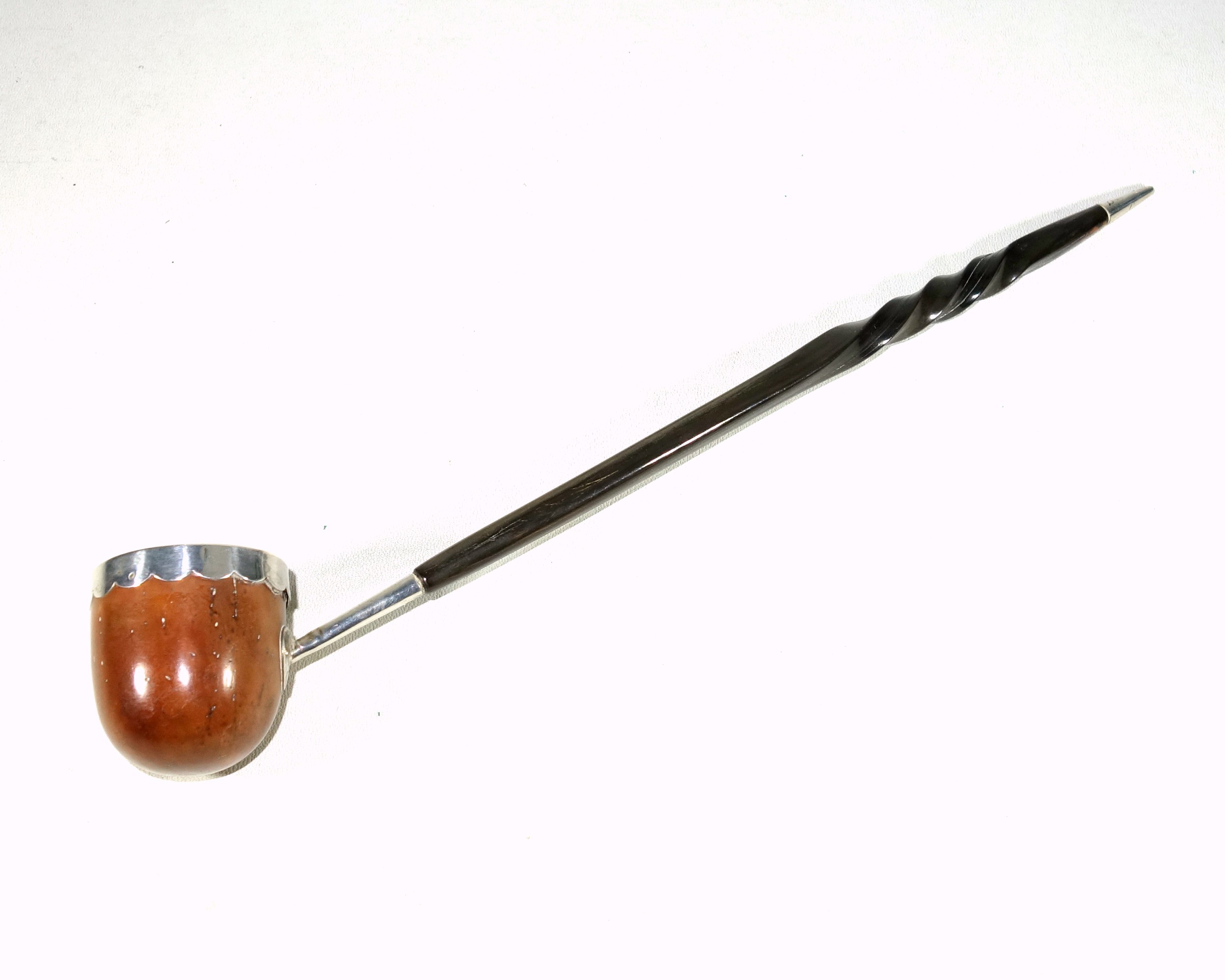 Georgian toddy ladle with a coquilla nut bowl and silver mounted rim, on a twisted whalebone handle,