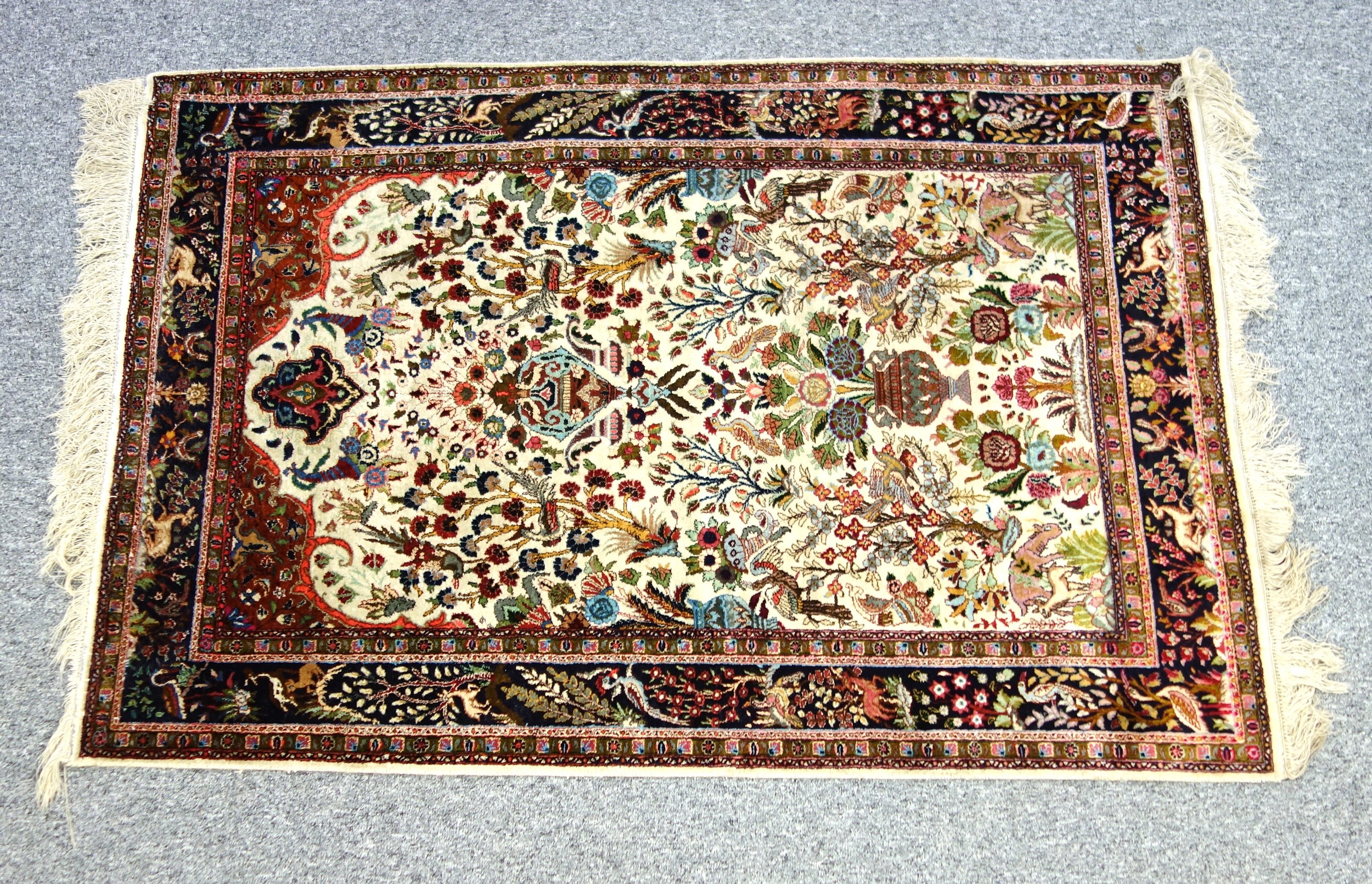Persian "Tree of Life" prayer rug, the ivory field with all-over flowering trees, animals, and birds