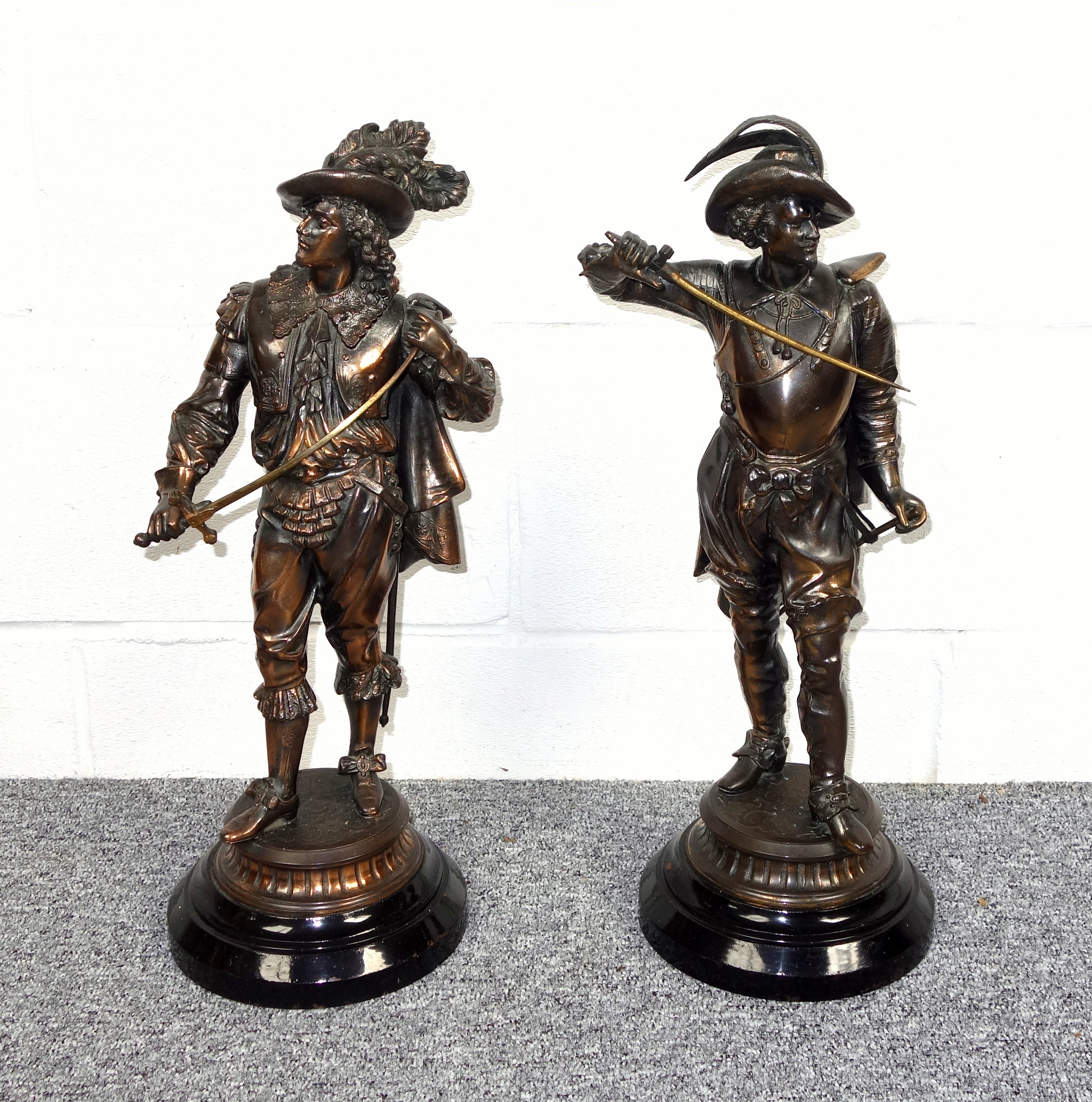 Pair of Late 19th Century French spelter figures of courtiers, each with a sword, standing on a