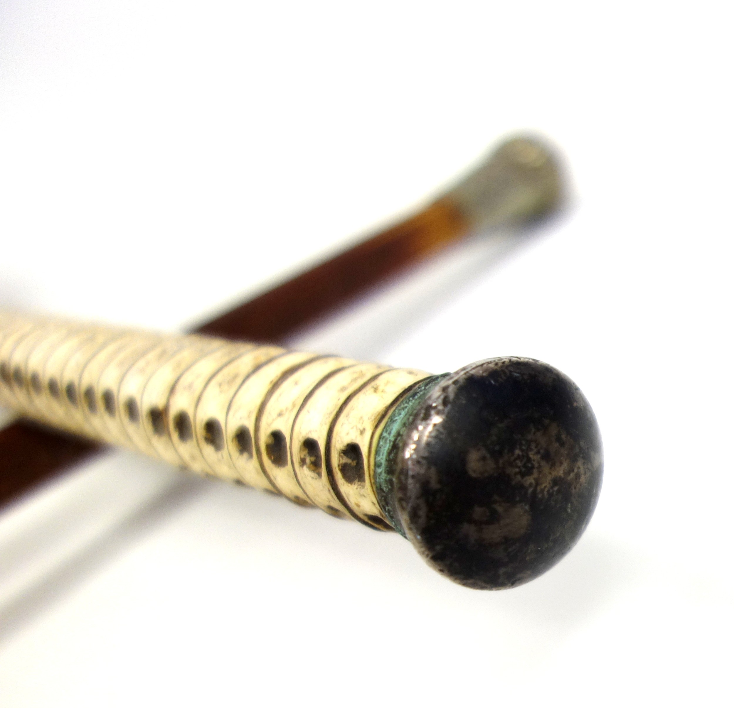Victorian vertebrae cane with a plated domed handle, L.86.5cm, and a military hardwood cane, the - Image 3 of 4