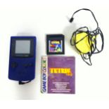 Game Boy Color with charger and Tetris game.