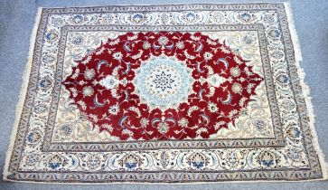 Persian carpet, the madder field with an anchor medallion and stylised floral decoration, surrounded