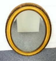 Edwardian wall mirror with an upright bevelled oval plate, in a gilt moulded frame, 86 x 60.5cm