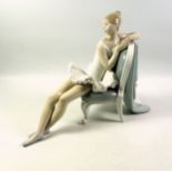 Lladro figure of a seated ballerina, 25cm high.