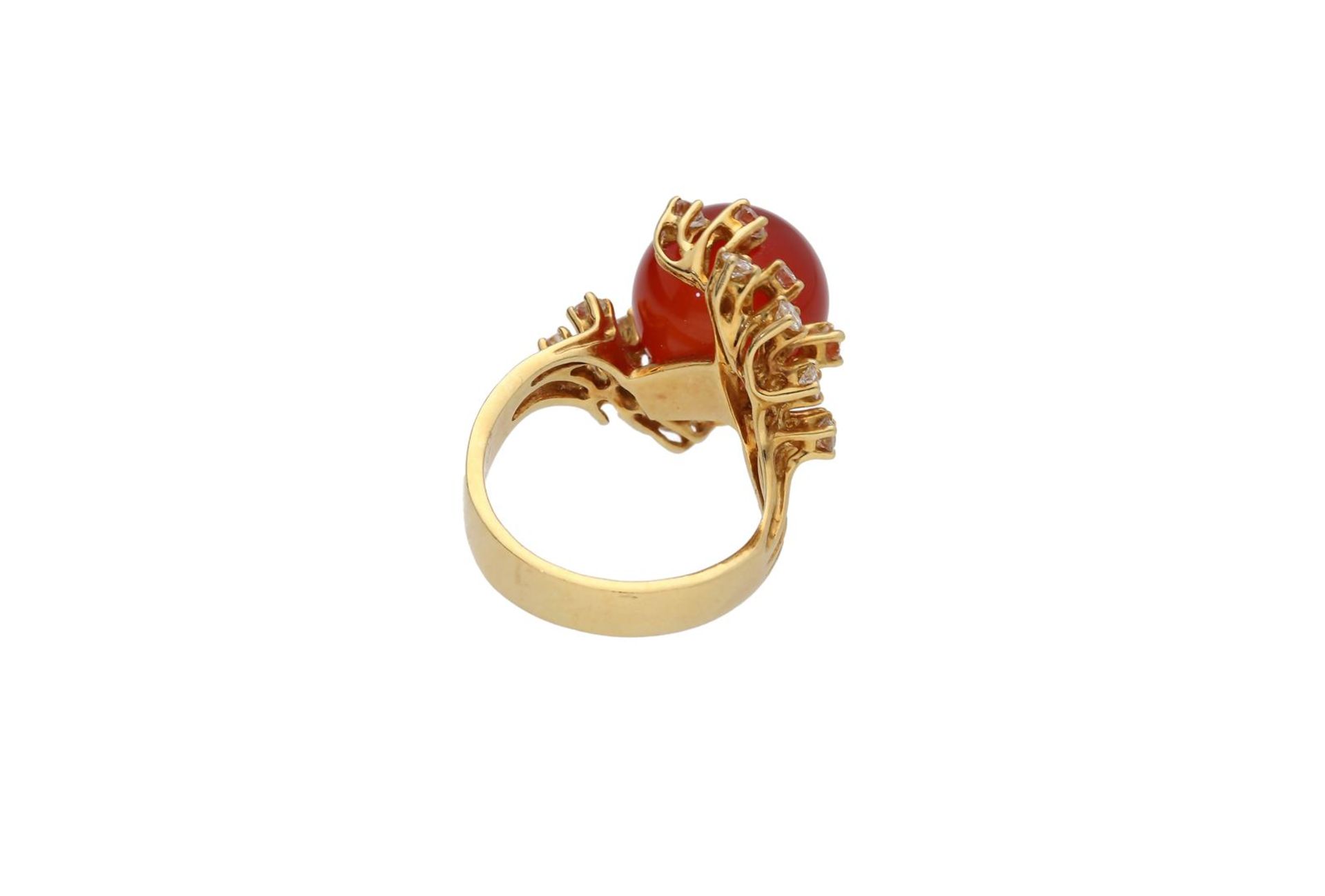 An 18-kt gold ring, set with a carnelian globe surrounded with brilliant cut diamonds, in total appr - Image 4 of 4