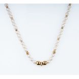 A Pearl Necklace with Goldchain Links.