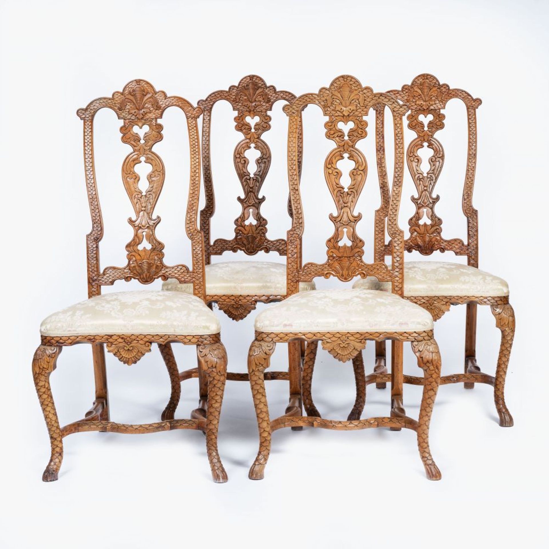 A Set of 4 Rococo Chairs with rare Scale Carving.