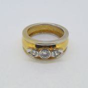 Yellow gold wide band ring set with 3 central diamonds. Marked 18CT