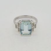 In white gold a step cut aquamarine and diamond ring. Aquamarine 2.98 cts Diamond 0.26 cts 18ct