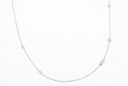 An 18ct white gold 18inch chain randomly set with multi-diamond shapes. Estimated total diamond