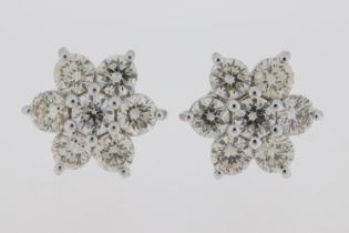 18ct White gold cluster earrings each comprising 7 diamonds, totalling 2.0 carats.