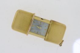 GOLD CASED MOVADO TRAVEL FOB REF 252, engine turned case, opens to revel Movado signed dial, winding