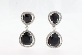 A pair of 18ct blue stone & diamond drop earrings.
