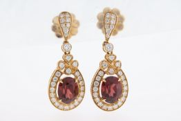 A pair of 18ct garnet & diamond drop earrings.