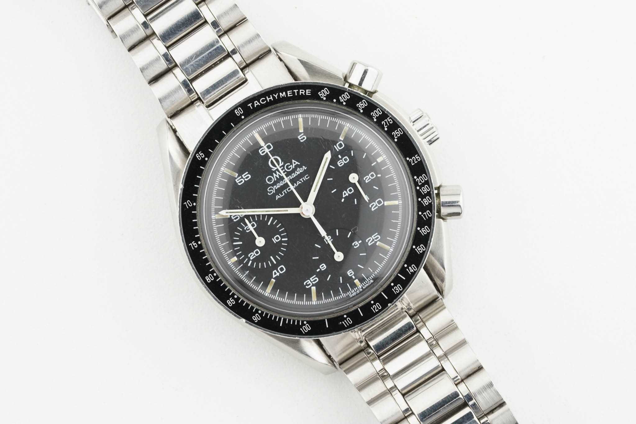 OMEGA SPEEDMASTER REDUCED W/ GUARANTEE CARD, circular black dial with hour markers and hands, 39mm