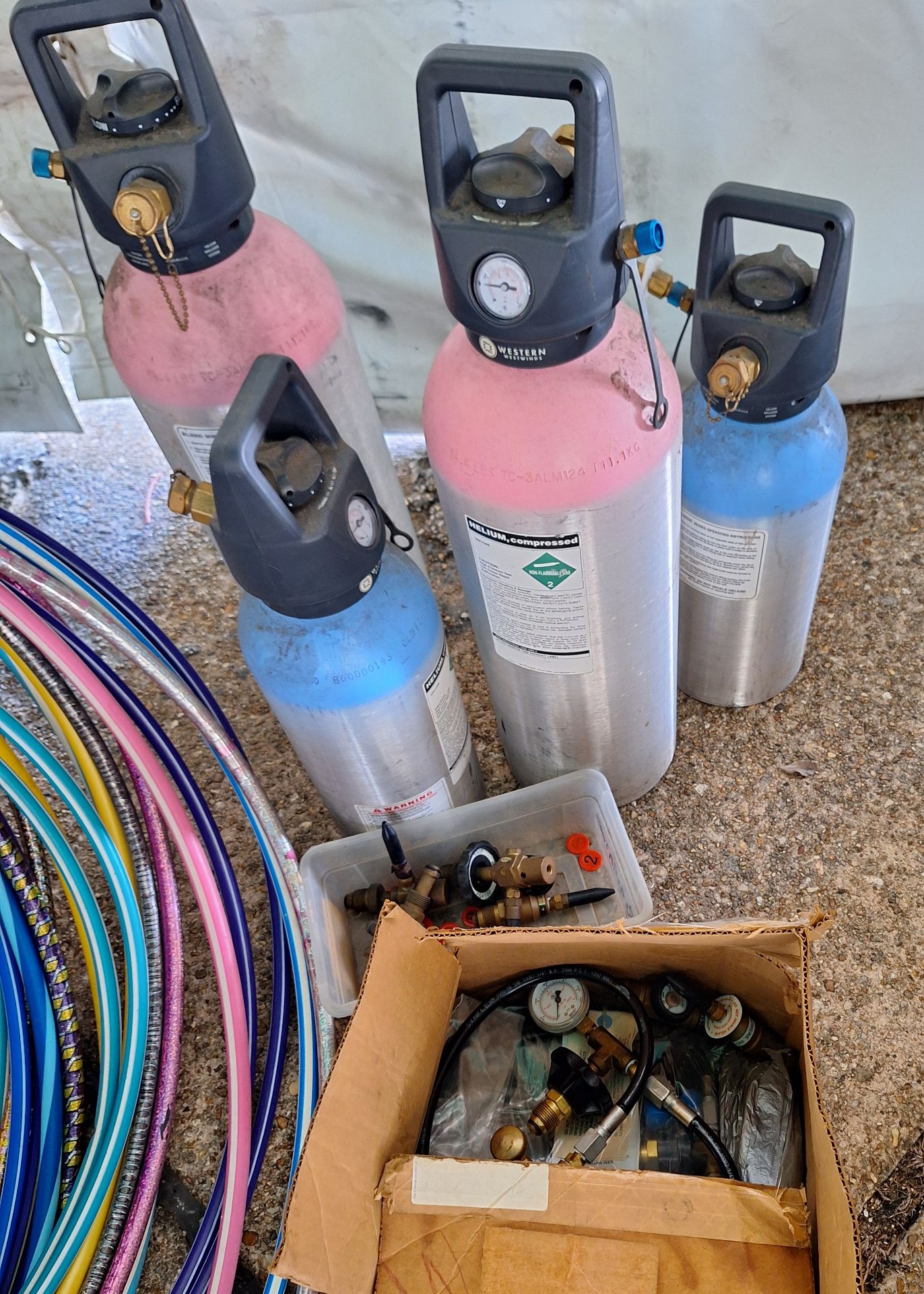 Assortment of helium tanks and valves