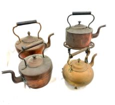 Selection of vintage copper and brass kettles with one stand