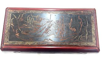 Oriental carved red and black lacquered box measures approximately 17 inches wide 7 inches tall 9