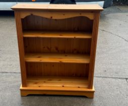 Pine three shelf bookcase measures approx 40 inches tall by 34 wide and 12 deep