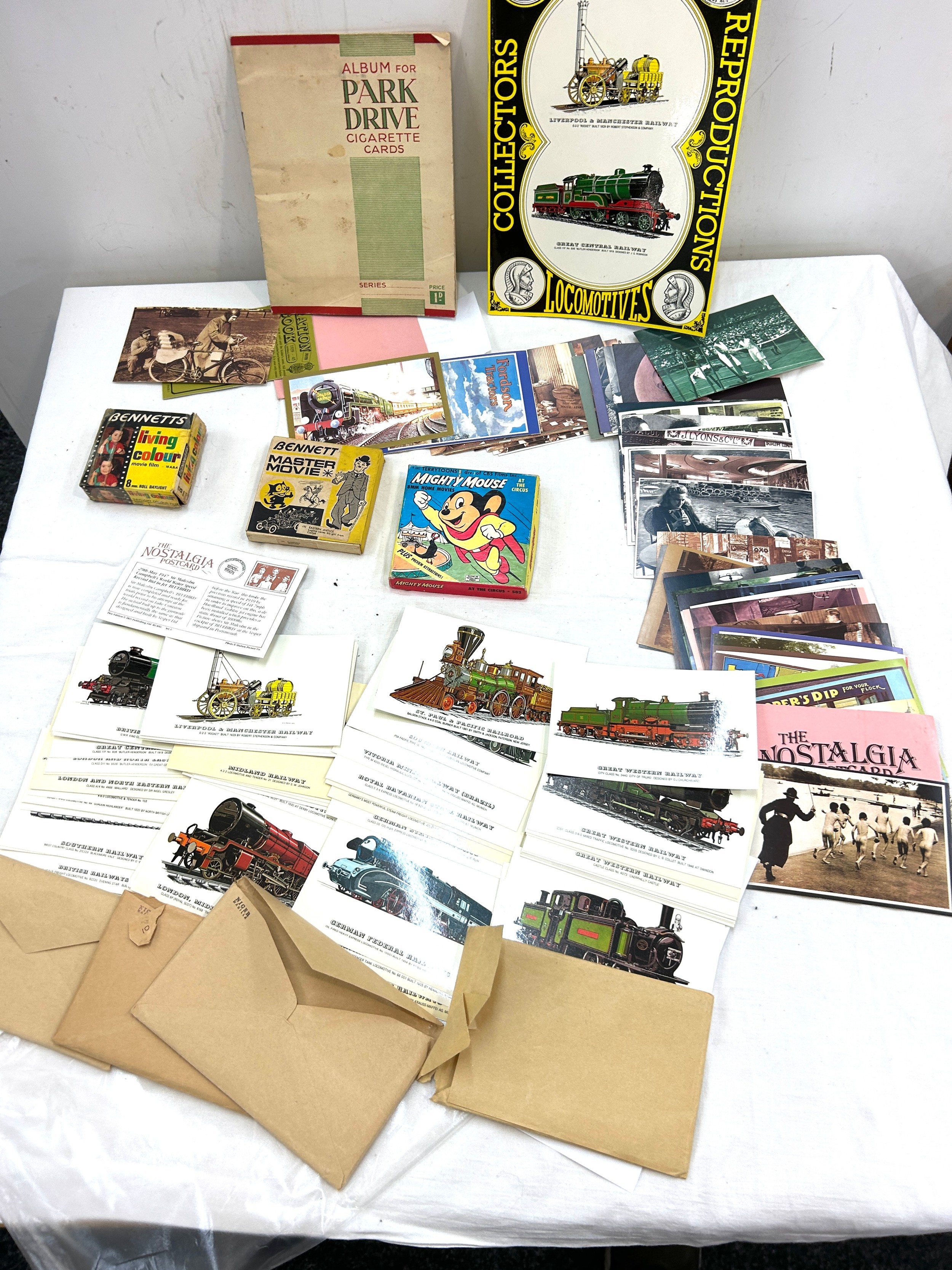 Selection of vintage postcards and cigarette cards along with vintage Bennetts movie films