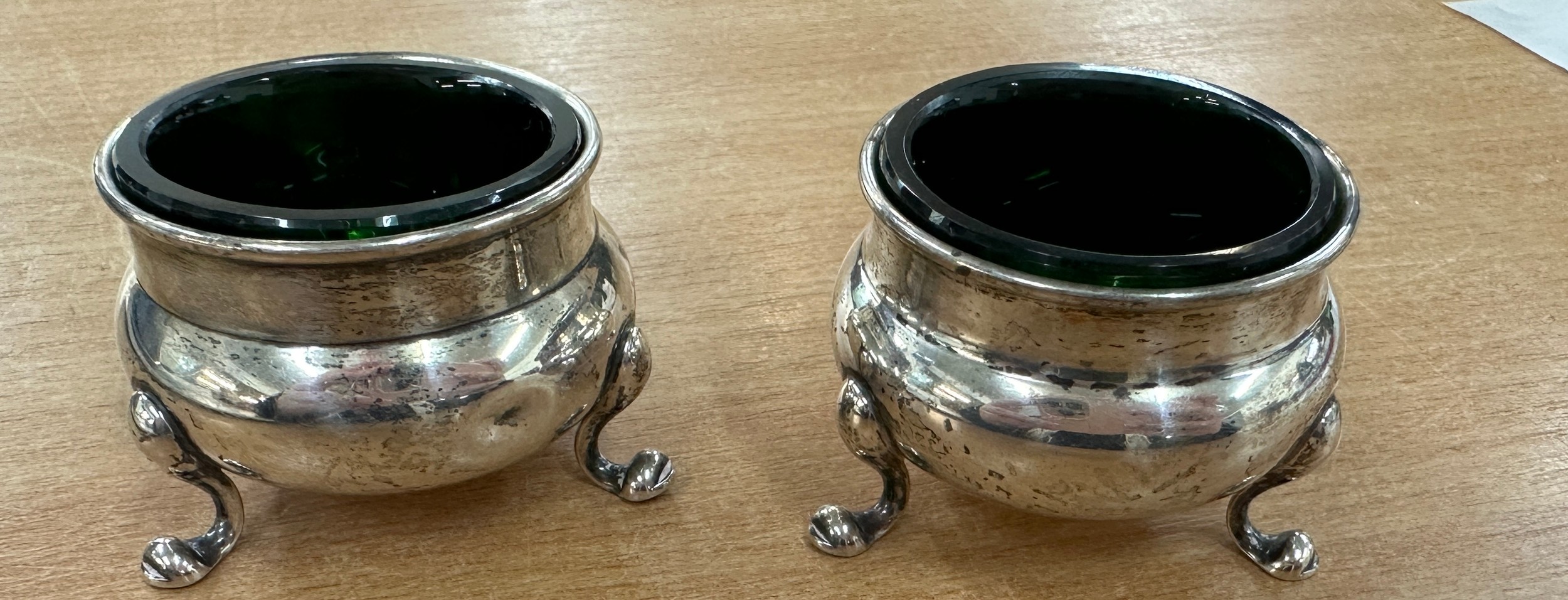 Two sterling silver salts with linens
