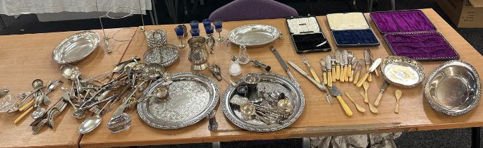 Large selection of silver plated ware includes lighters, cutlery, salt and pepper and a selection of