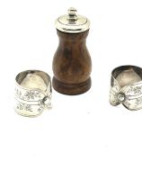 Sterling silver top pepper grinder and pair of silver plated shirt collar napkin rings