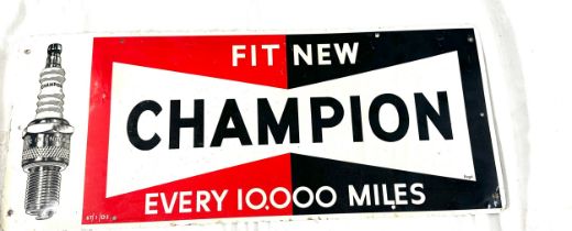 Champion spark plugs tin advertising sign measures approximately 9.5 inches tall 23 inches wide