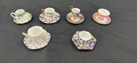 Selection of miniature cups and saucers