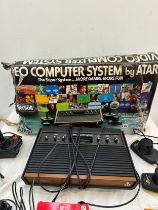 Vintage Atari CX-2600 with combat game program, pacman and space invaders, joystick and paddles, all