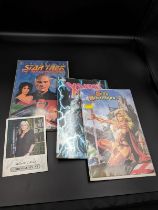 Three collector comic books, including Star Trek: The Next Generation, and Marvel's X-Men, along