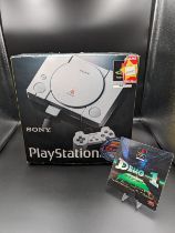 Original Sony PlayStation (PS1) console, preserved in its original box. Wires, dual controllers, and