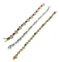 Three silver stone set bracelets including emerald and ruby (36g)