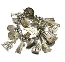 A vintage silver charm bracelet with assorted novelty charms (77g)