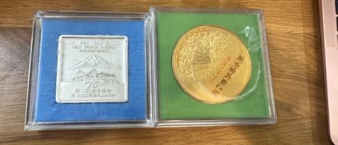 Two oriental coins ' 10th NSA Convention' and ' Tower of World peace'