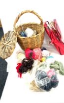 Lidded wicker basket with a selection of assorted knitting equipment