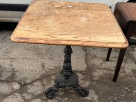 Cast iron base pub table measyres approximately 27 inches tall 26 inches square