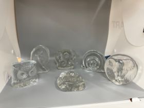 Selection of flat back glass paper weights includes Swedish glass, some signed, snail, elephants,