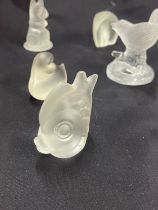 Selection of frosted glass paper weights includes lions, elephants, dogs etc