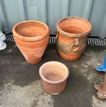 three terracotta plant pots largest measures approx 12 inches tall by 11 inches diameter