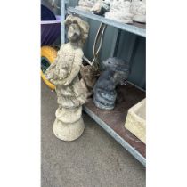 Three outdoor stone figures to include a lady etc