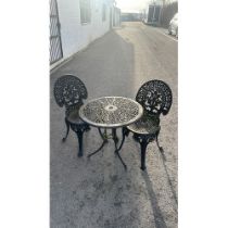 cast iron table and two chairs