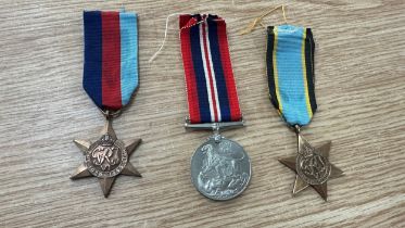 Three WW2 medals to include genuine defence medal, star medal genuine and a Europe Star replica