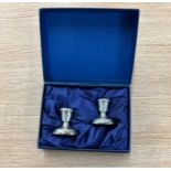 Two miniature silver candle sticks hallmarked 925 in case