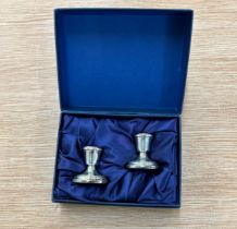 Two miniature silver candle sticks hallmarked 925 in case