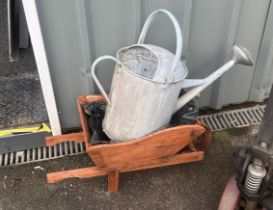 Galvanished watering jug and a wheel barrow planter