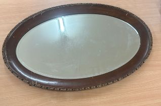 Oval oak framed mirror measures approximately 32 inches wide 21 inches tall