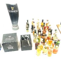 Selection of miniature alcohol bottles along with a Guiness beer pump and other